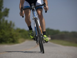 Sport cyclist on bike on country road