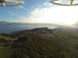 Drone footage of green landscape, lake and clear skies