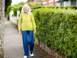 Older resident walking down street in Belfast neighbourhood