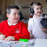 Two young boys drawing and recording stories about Sailortown