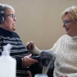 Two women listening to audio at the Memory Anchors co-creation session
